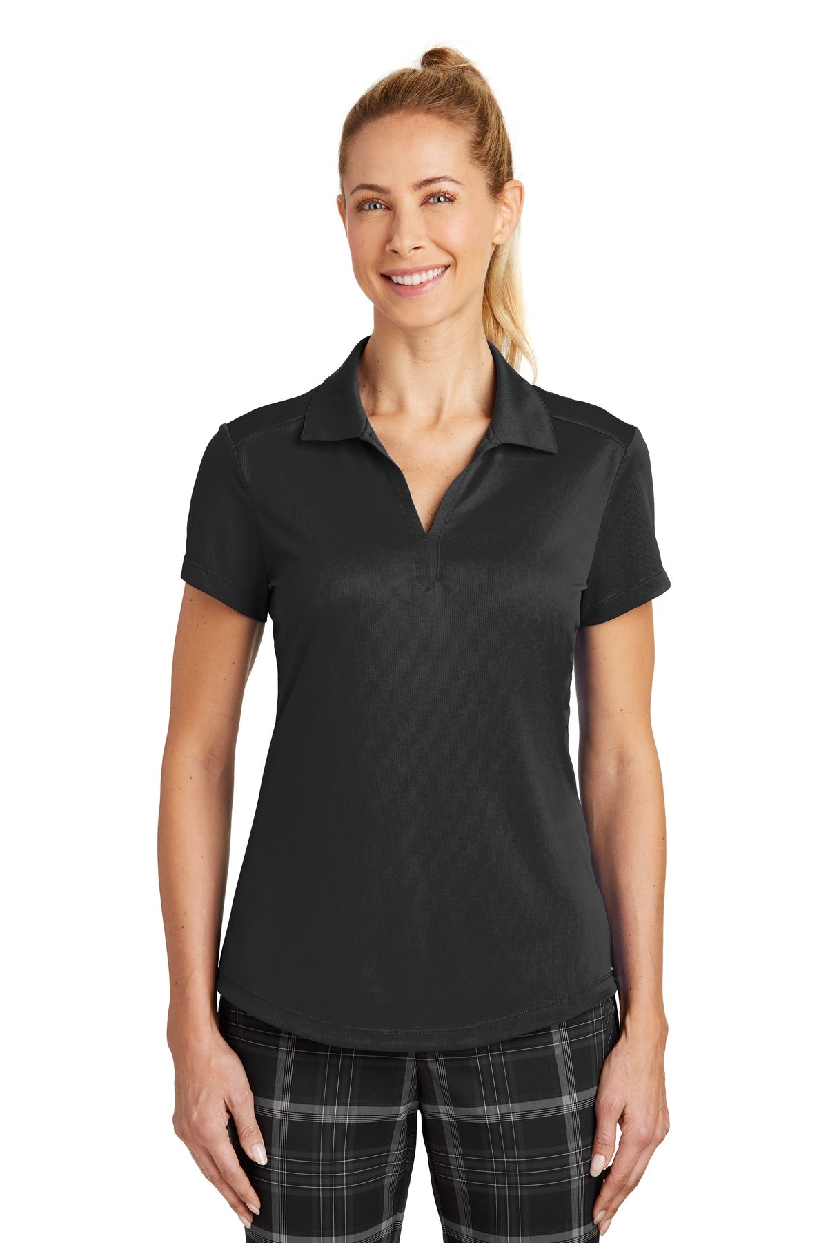 Black Nike Women's Dri-FIT Legacy Polo shirt worn by a model, showing the front view with Nike logo and polo collar.