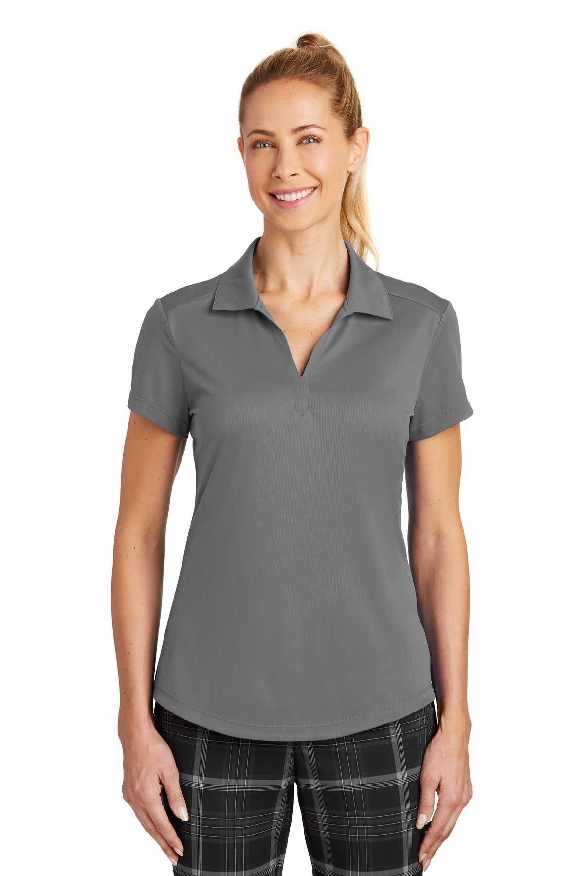 Nike Women's Dri-FIT Legacy Polo in dark grey, front view on model, showcasing lightweight athletic fabric and classic polo style.