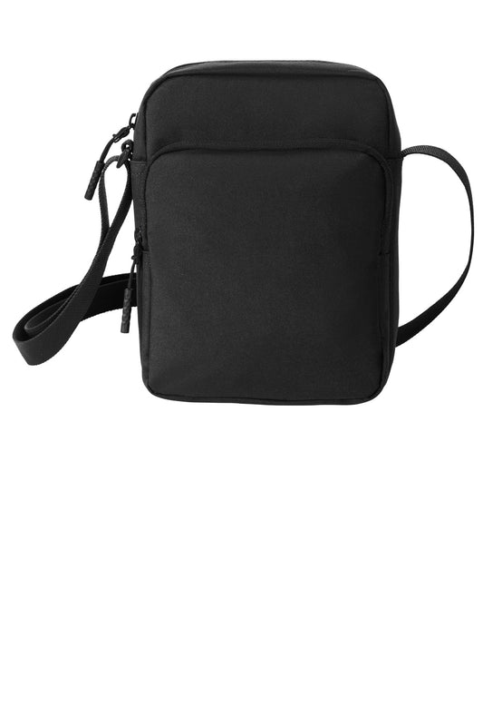 Black Port Authority upright crossbody bag with adjustable strap and multiple compartments on a plain background.