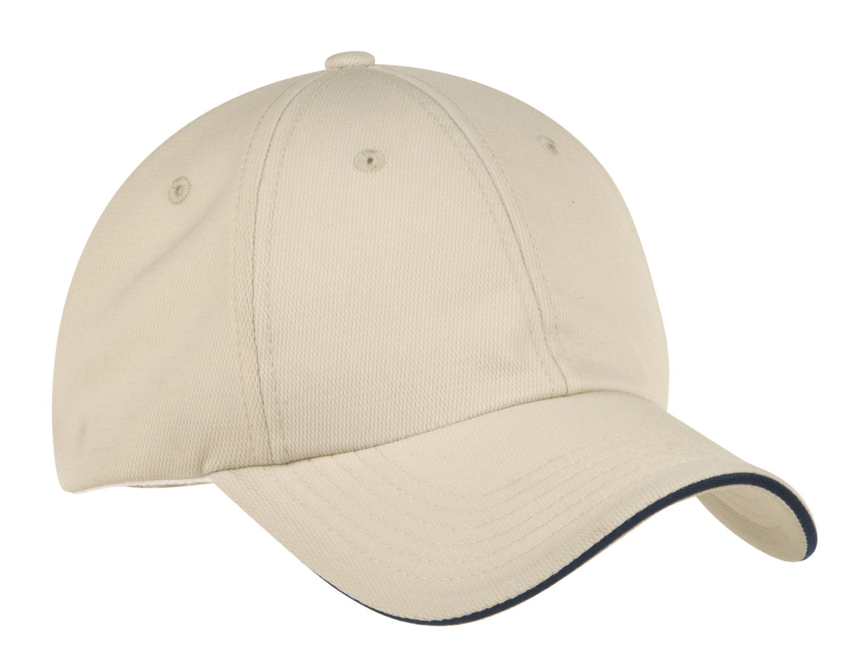 Port Authority Dry Zone cap in stone and navy, showing front view with adjustable strap and curved brim.