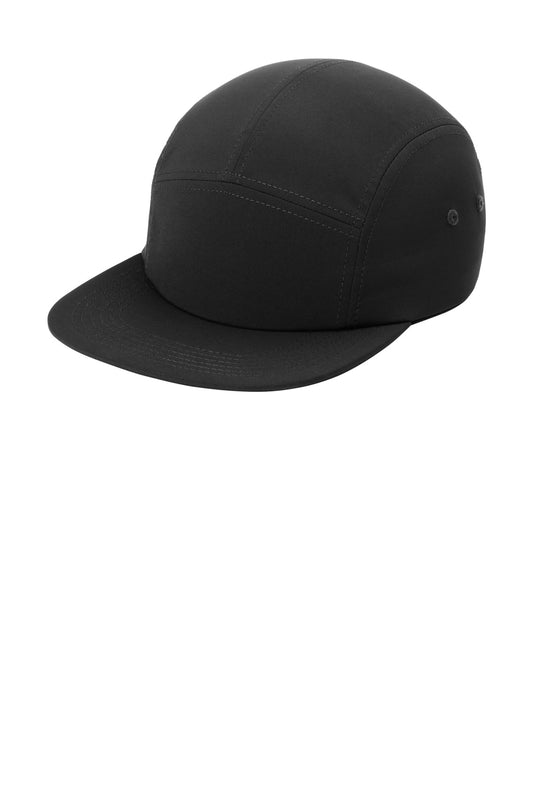Black Port Authority Poly Camper Cap with curved brim and adjustable strap, shown from the left side.