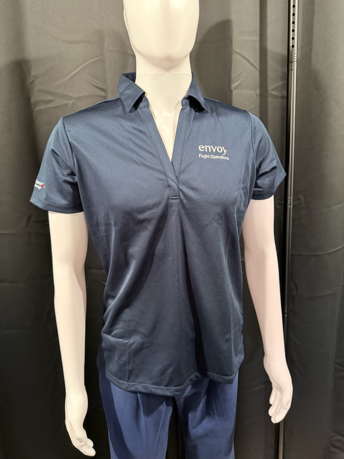 Angelheart Embroidery women's Envoy New Hire Bundle with branded apparel, including shirts and accessories, on a flat lay.