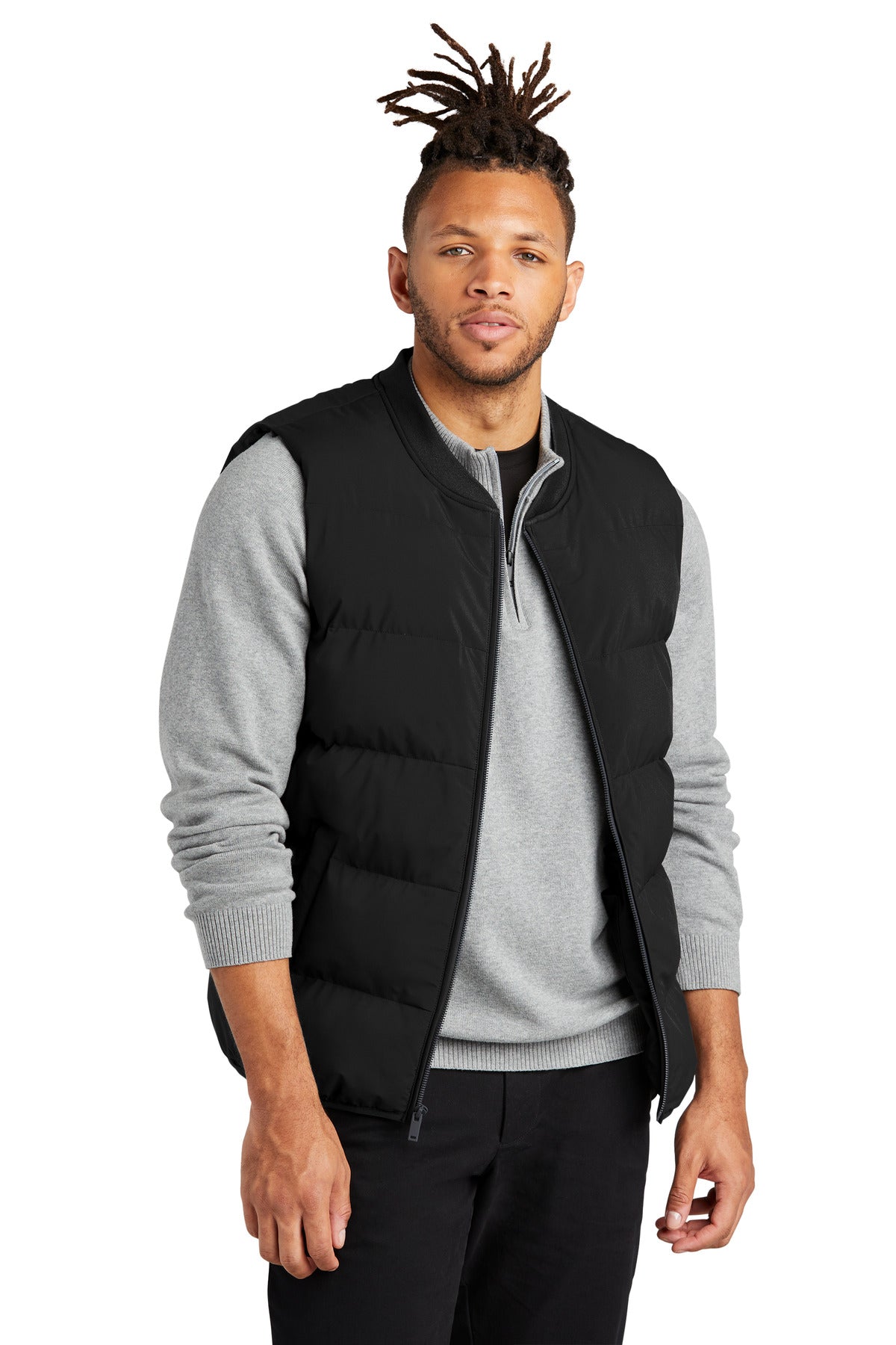 Mercer+Mettle puffy vest MM7214 in deep black, worn by a model, showcasing front view with quilted design and stand collar.