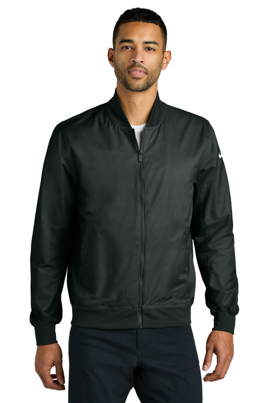 Black Nike Bomber Jacket NKFQ4759 front view on male model, showcasing sleek design and classic fit.