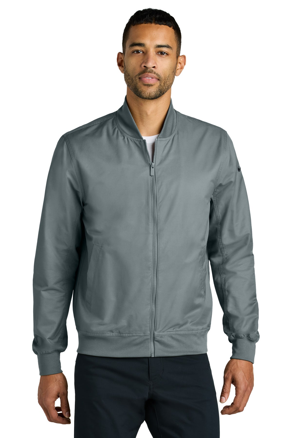Nike bomber jacket in cool grey, front view showing stylish design and fitted silhouette on a model.